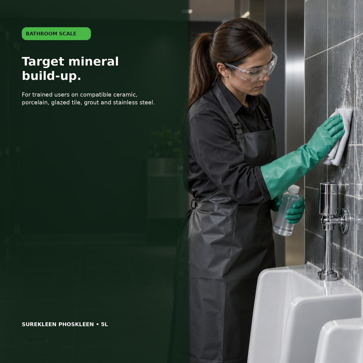 Trained cleaner descaling glazed bathroom tiles while wearing acid-resistant PPE

