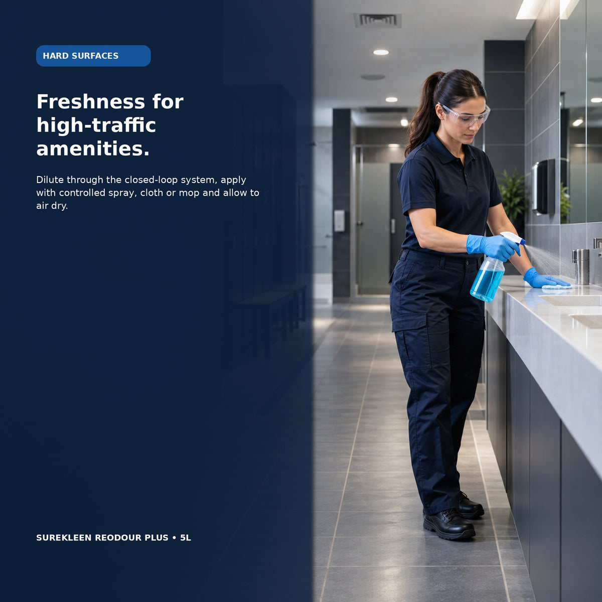 Professional cleaner deodorising a commercial amenities room with gloves and eye protection
