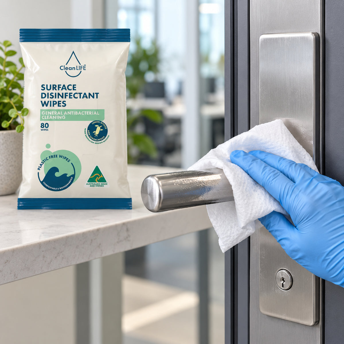 CleanLIFE disinfectant wipe cleaning a workplace door handle
