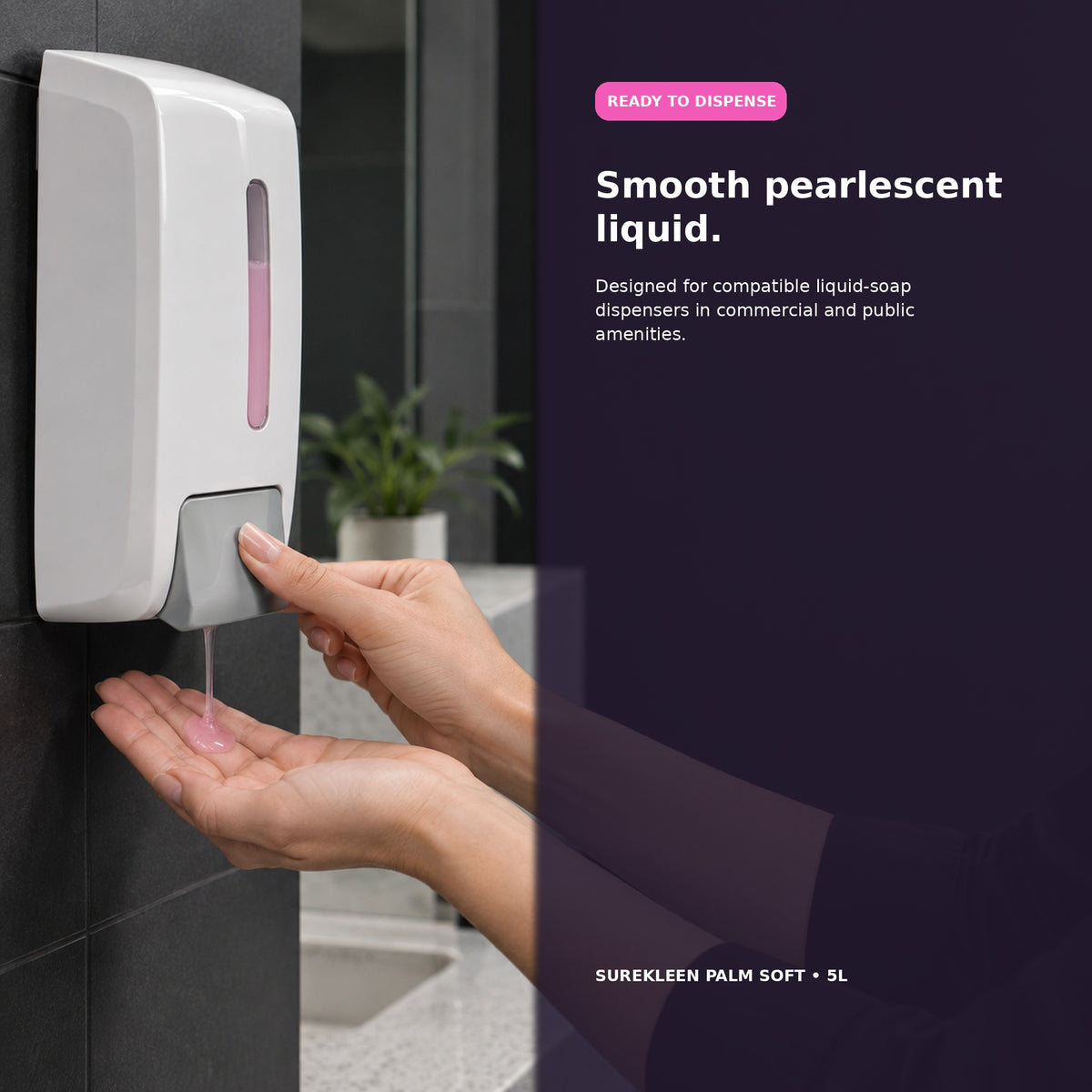 Hands dispensing pink liquid hand wash from a commercial soap dispenser
