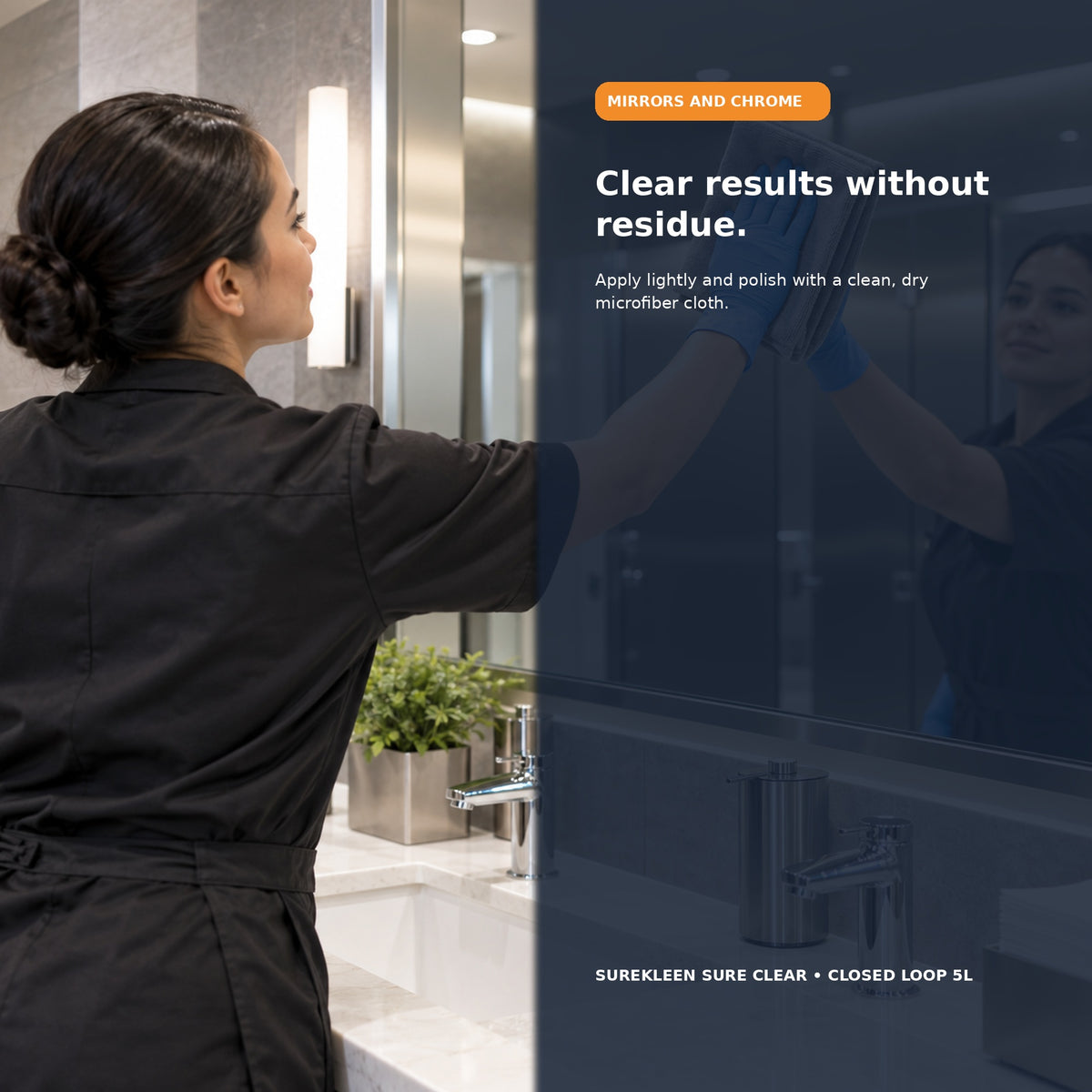 Professional polishing a commercial washroom mirror with a microfiber cloth
