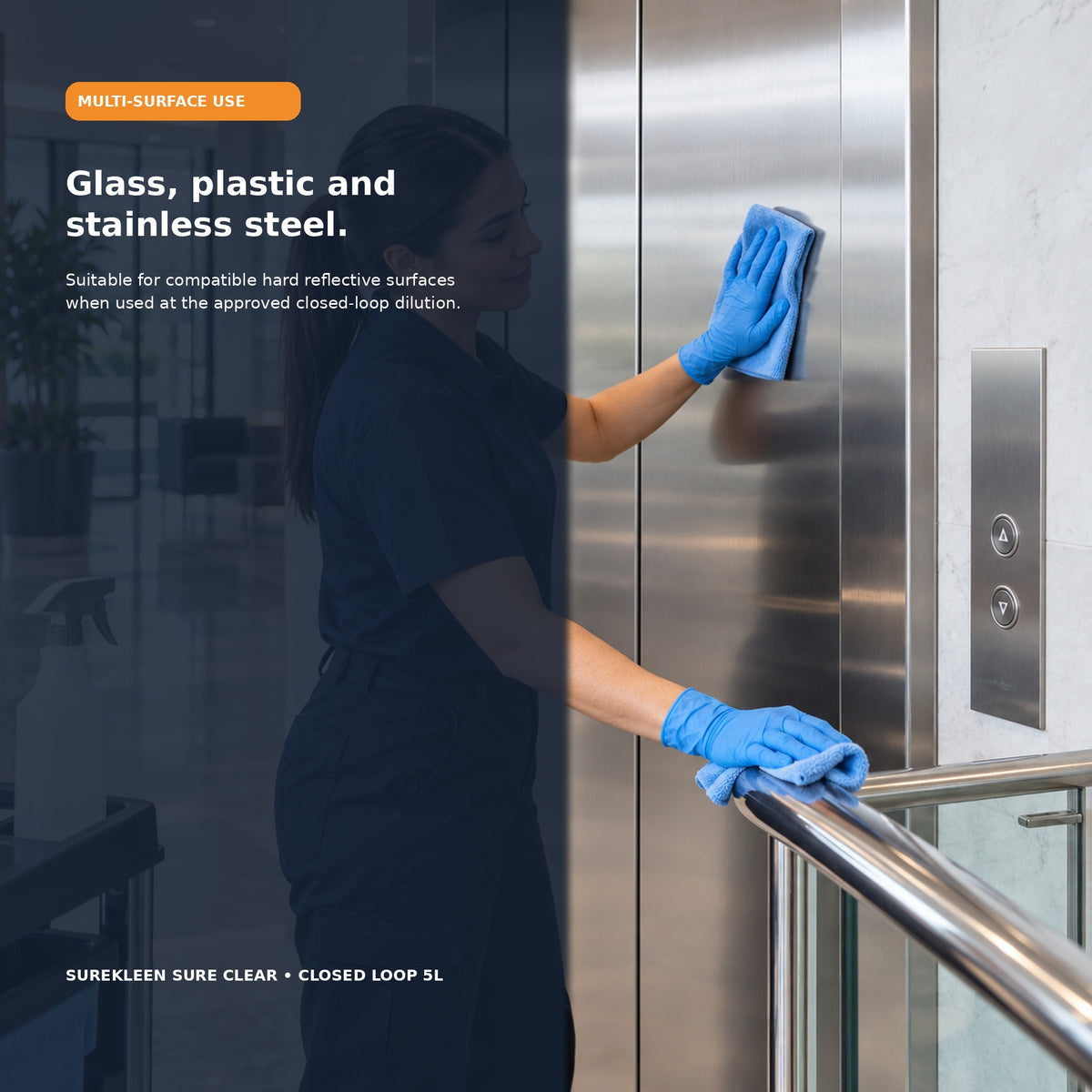 Cleaner polishing stainless steel elevator doors and a chrome handrail
